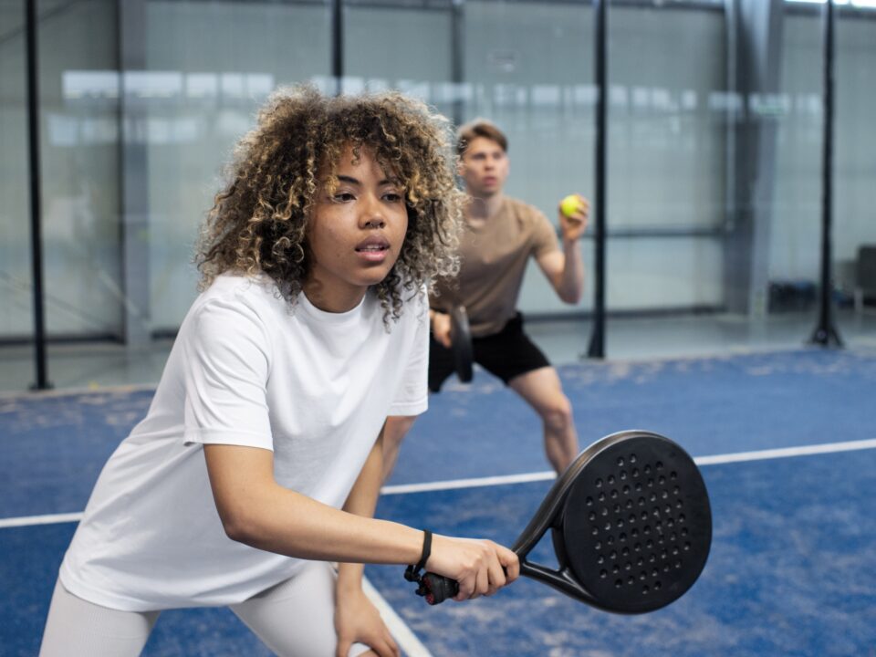 people-playing-paddle-tennis-inside